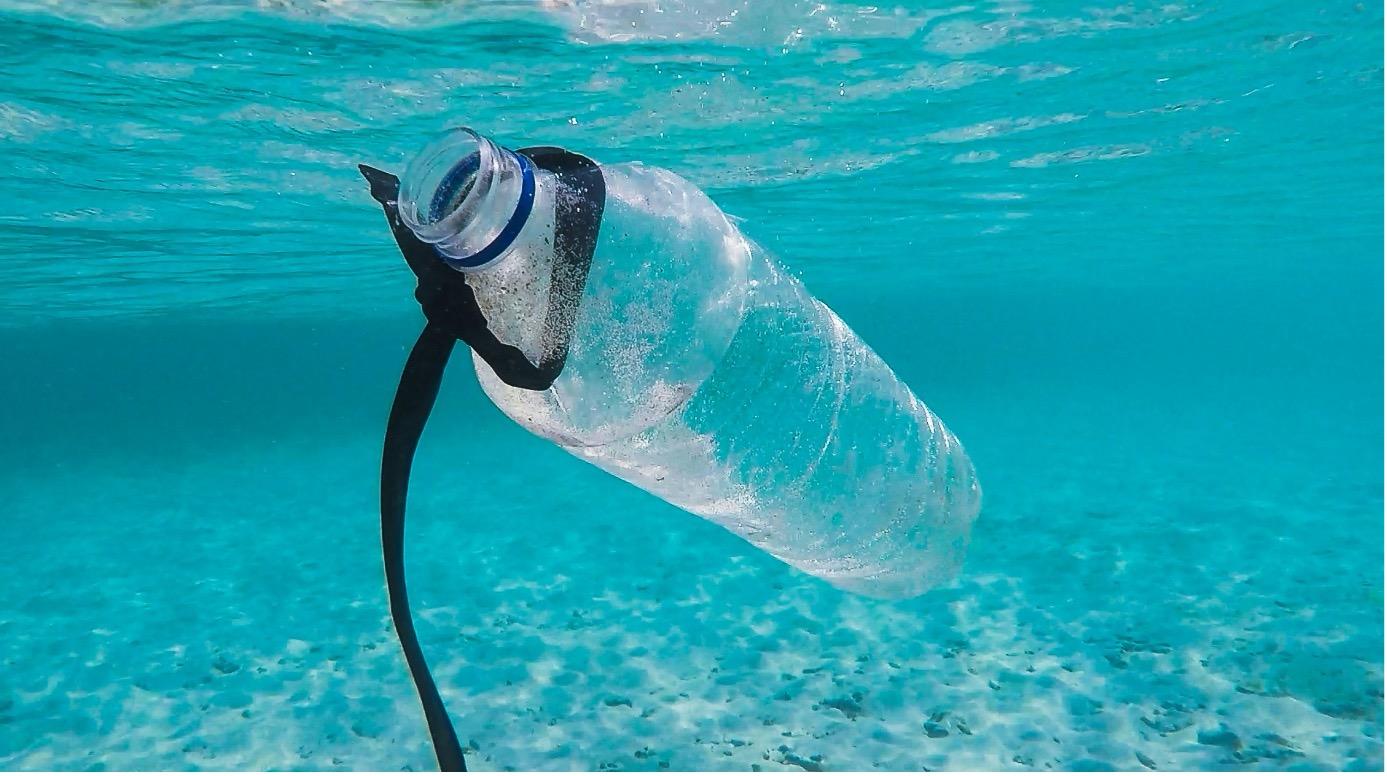 a photo of a bottle in the ocean